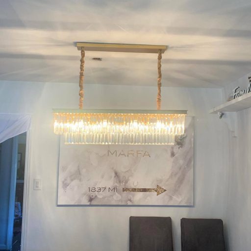 Chandelier lighting a renovated living room