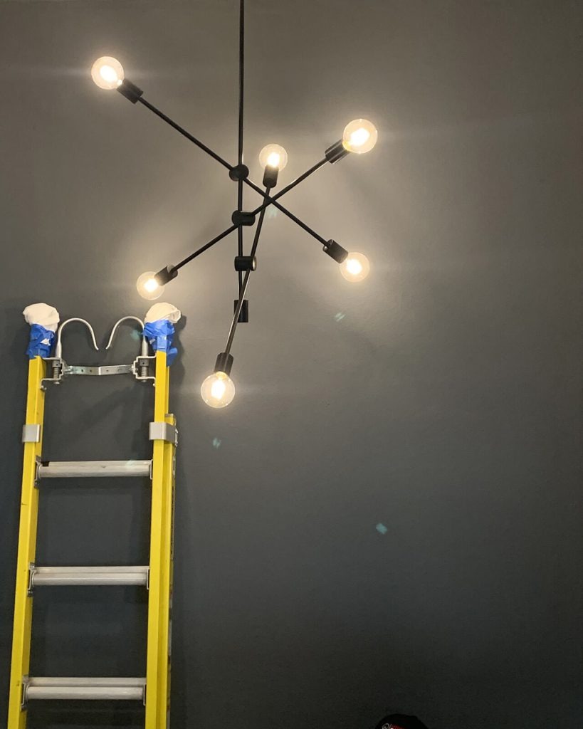 Modern pendant light fixture installed over dining table