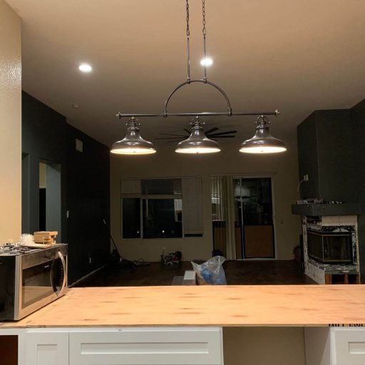 Pendant light fixtures aligned above a dining table
