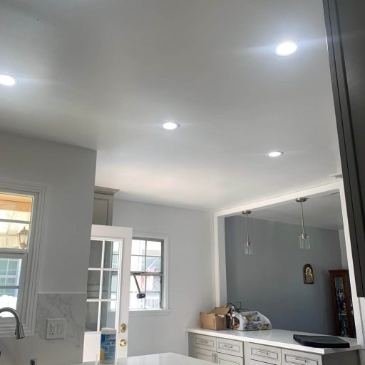 Finished recessed lighting illuminating a kitchen ceiling